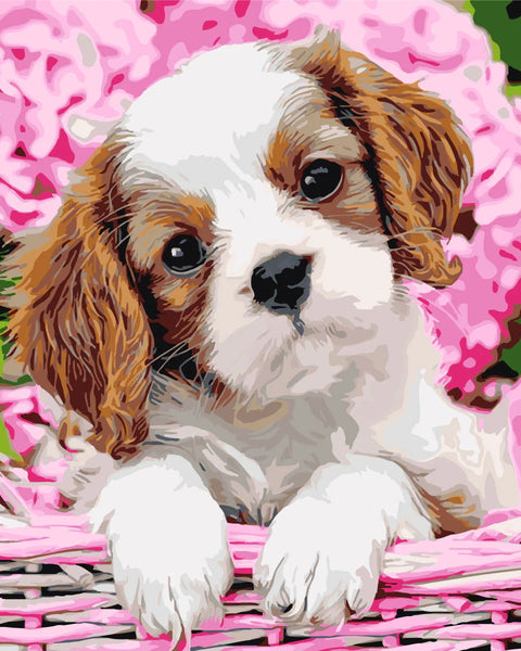 Adorable puppy in basket surrounded by pink hydrangea flowers