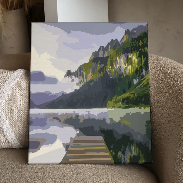Painting of a peaceful lake with mountains and a wooden dock