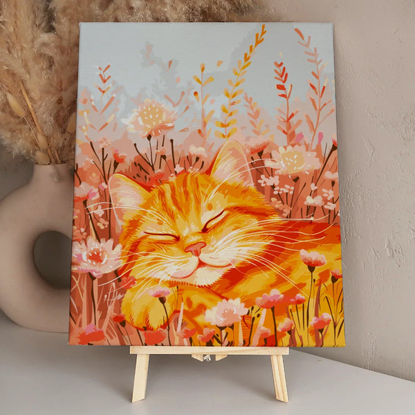Smiling orange cat peacefully resting among blooming wildflowers