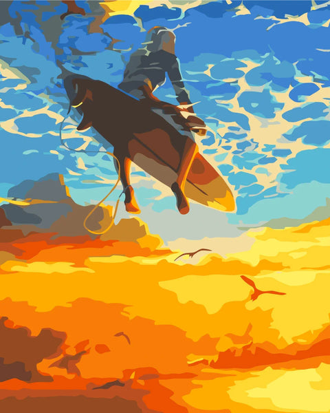 Surfer soaring above the ocean with a vibrant sunset sky