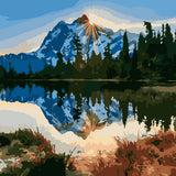 Mountain landscape with sunlit peak reflected in a tranquil lake