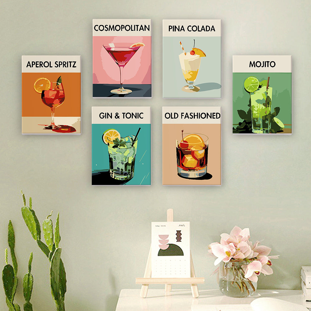 Sip Society cocktail canvas set of 6 paint by numbers displayed on a wall. Includes stylish paintings of iconic cocktails: Aperol Spritz, Cosmopolitan, Pina Colada, Mojito, Gin & Tonic, and Old Fashioned. Perfect decor for cocktail enthusiasts and modern art lovers by Artspark.