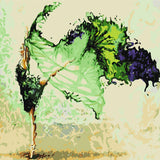 Graceful ballerina dancing with flowing green and black dress