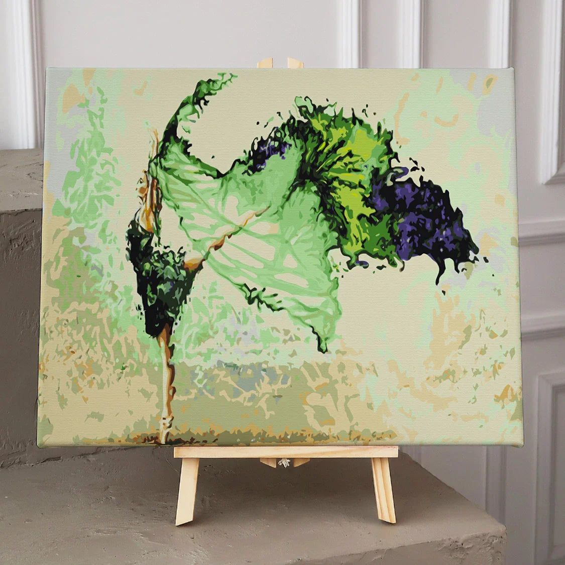 Graceful ballerina dancing with flowing green and black dress
