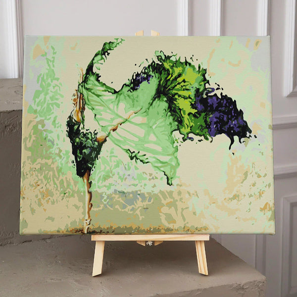 Graceful ballerina dancing with flowing green and black dress