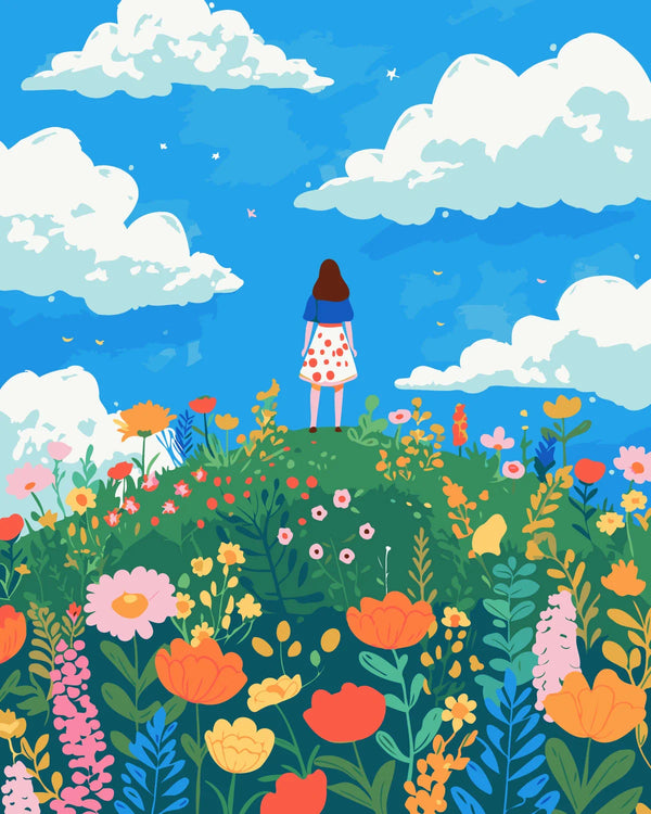 Woman standing on a hill surrounded by colorful wildflowers