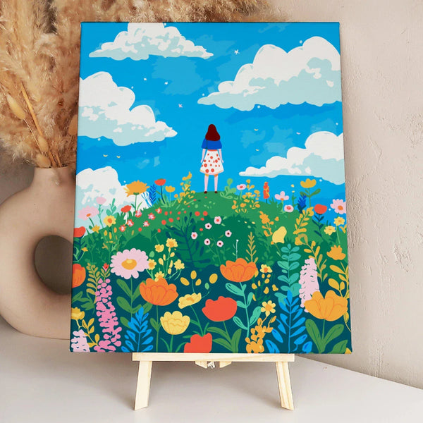 Woman standing on a hill surrounded by colorful wildflowers