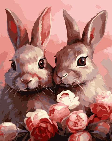 Two adorable rabbits surrounded by pink and red blooming flowers