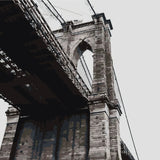 Painting of Brooklyn Bridge from a low-angle perspective in grayscale