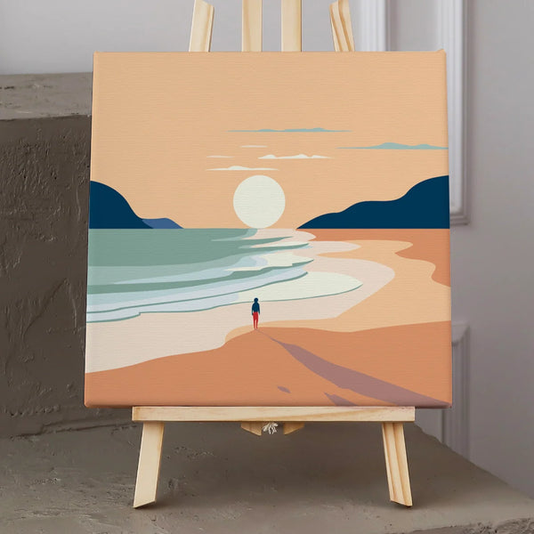 Person walking on a sandy beach towards the sunset over ocean