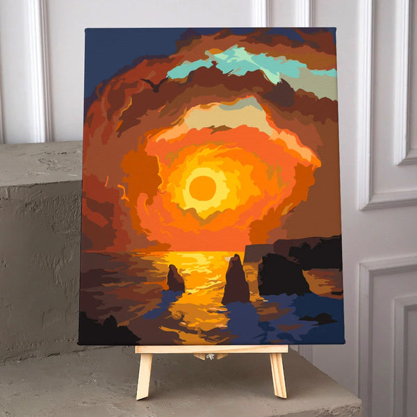Vibrant sunset over ocean with dramatic clouds and rock formations