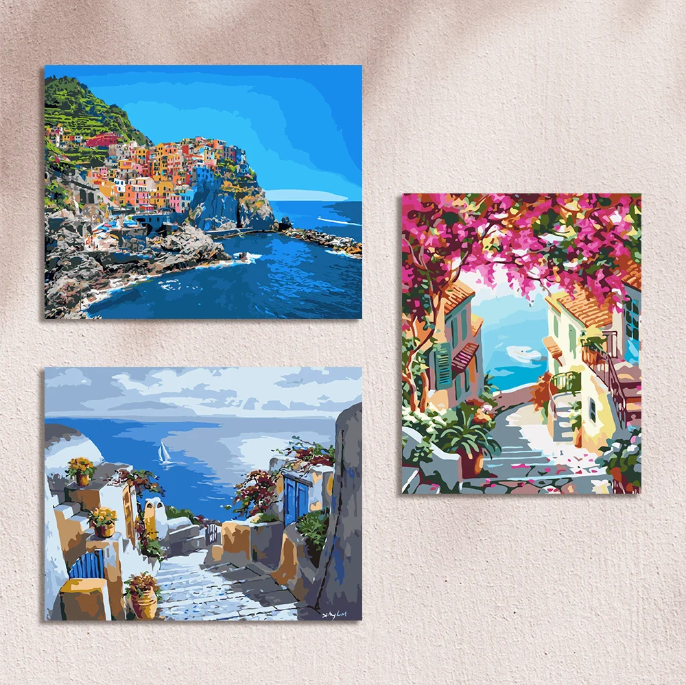 Paintings of colorful coastal villages with ocean views and flowers