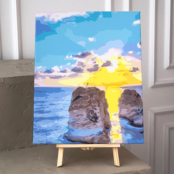 Colorful painting of a sunset over ocean cliffs with reflection