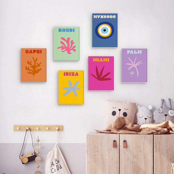 Coastal Dreams Paint by Numbers Kit by Artspark displayed on a wall featuring six coastal-themed canvases: Bondi, Palm, Capri, Ibiza, Miami, Mykonos.