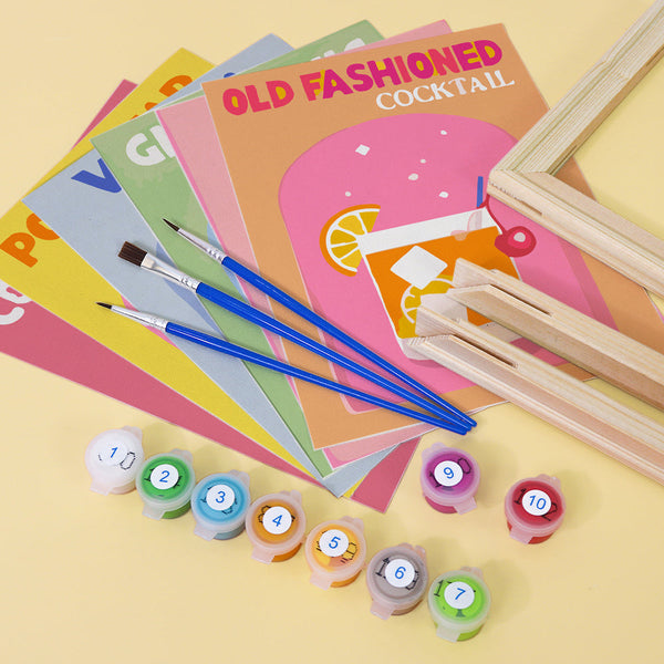 Cocktail Cuties Paint by Numbers Kit by Artspark - Unframed linen canvases, brushes, acrylic paints, and wooden frames for creating classic cocktail-themed artwork.