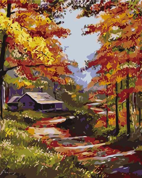 Autumn forest landscape with colorful trees and a cozy cabin