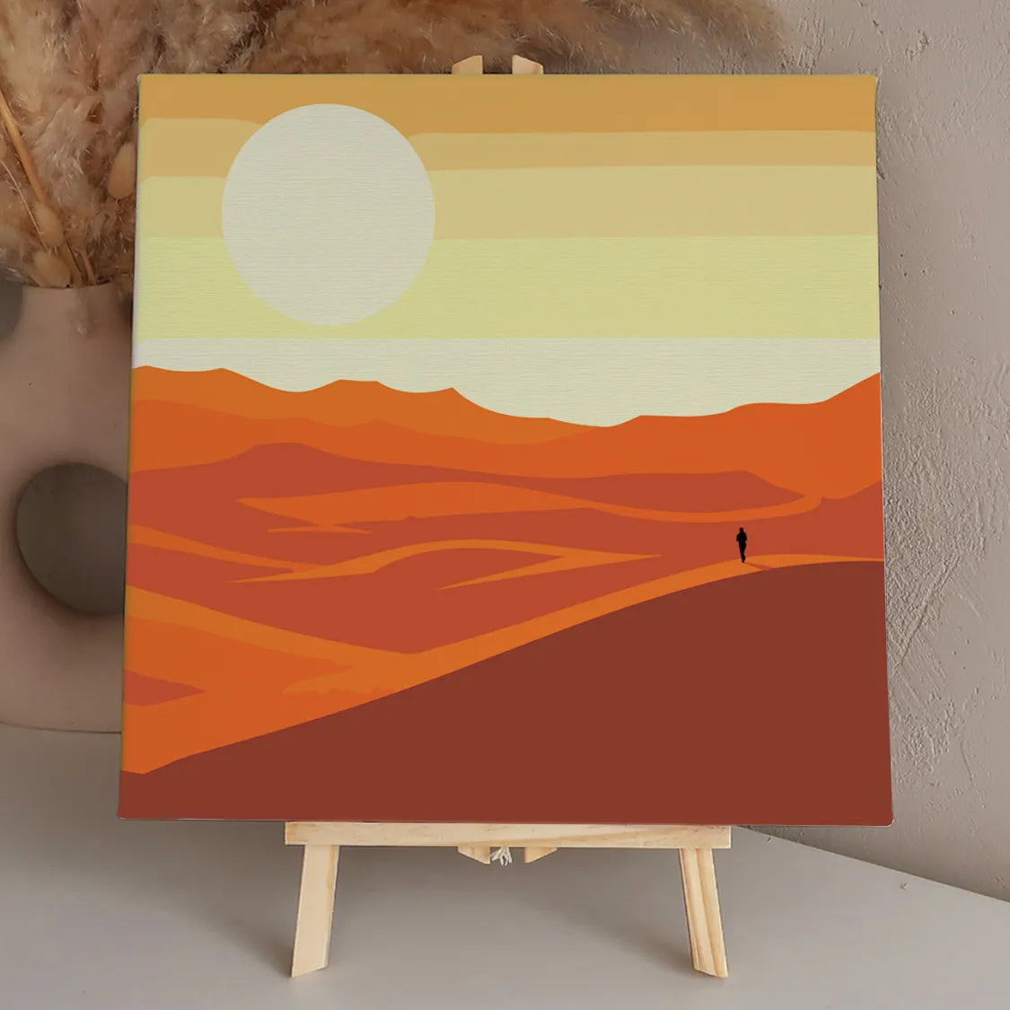 Minimalist desert landscape with a lone traveler under a large sun