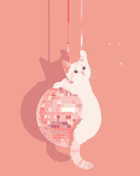 White cat playfully hanging onto a pink disco ball