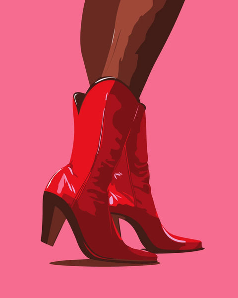 Stylish red cowboy boots on a woman's legs against pink background