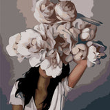 Surreal portrait of a woman with flowers and a bird