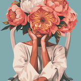 Woman sitting on chair with oversized flowers covering her face