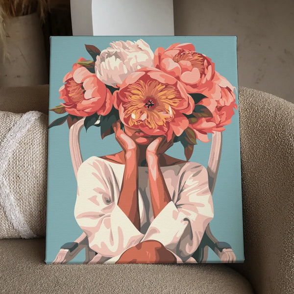 Woman sitting on chair with oversized flowers covering her face
