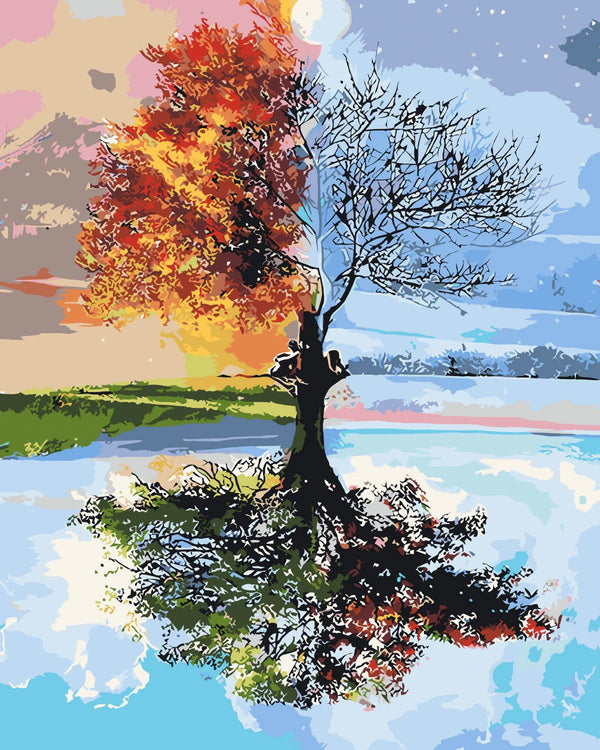A tree depicting both summer and winter with a reflective lake