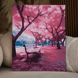 Serene park scene with cherry blossom trees and empty bench