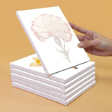 Unpainted canvas featuring a detailed outline of a carnation flower from the Garden Whispers Paint by Numbers Kit. Canvas stacked with others, highlighting the precision and quality of the Artspark kit.