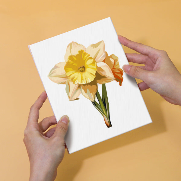 Completed painting of a bright yellow daffodil from the Garden Whispers Paint by Numbers Kit. Held by hands, showcasing vibrant petals and realistic detailing from the Artspark kit.