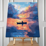 Silhouette of a person rowing a boat on a sunset-lit lake