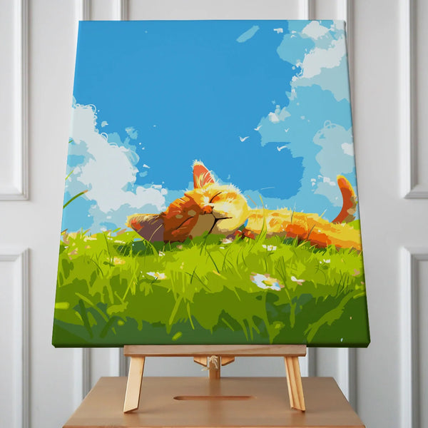 Orange cat relaxing on a grassy field under a blue sky