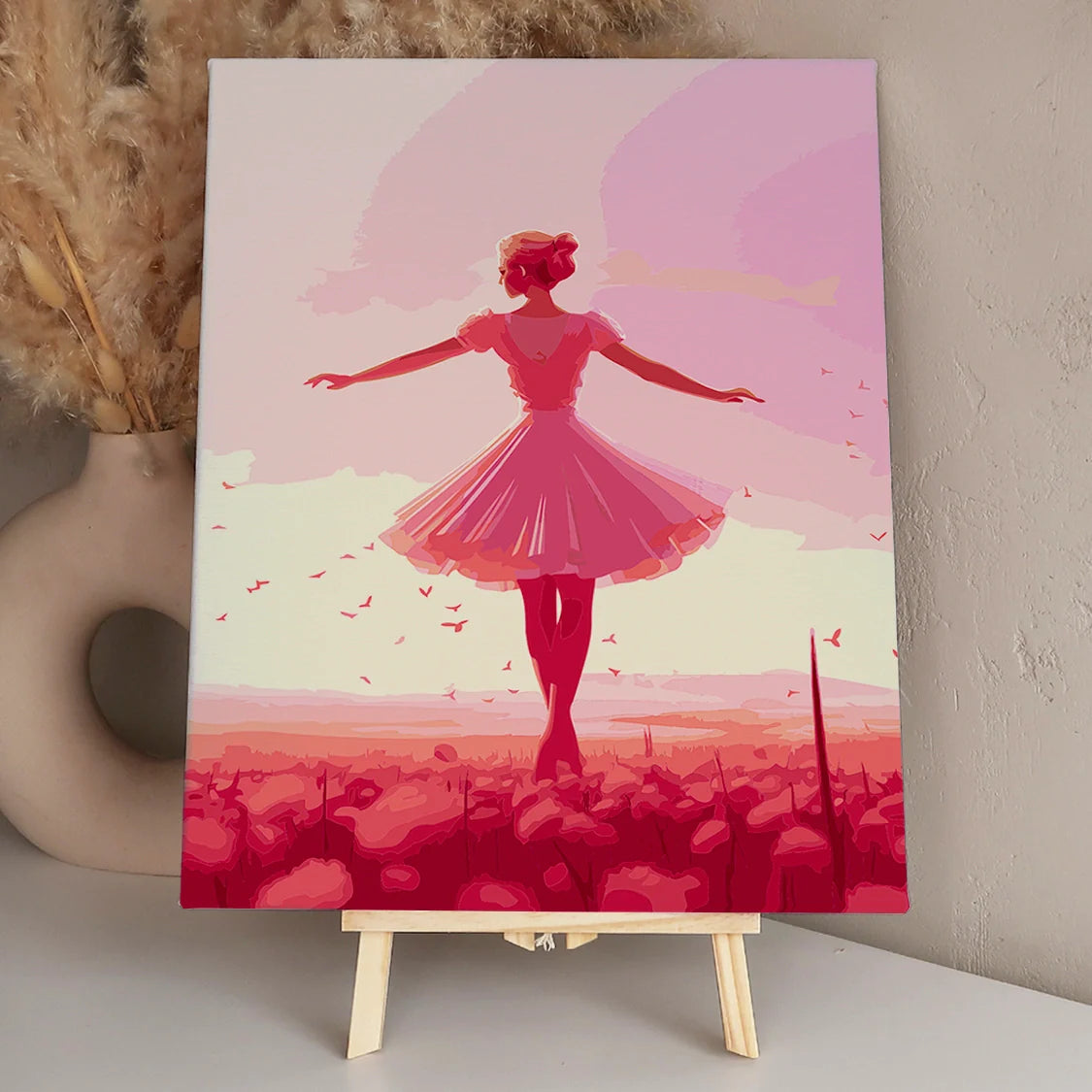 Elegant ballerina dancing in a dreamy pink floral landscape.