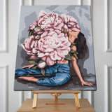 Woman with oversized blooming peonies covering her head and body