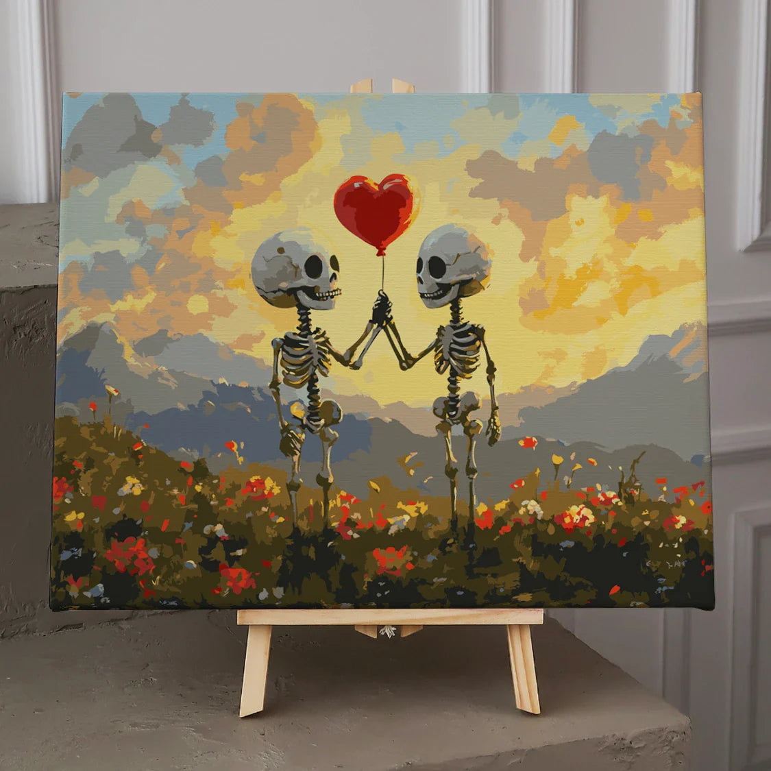 Two skeletons holding a heart balloon in a sunset field