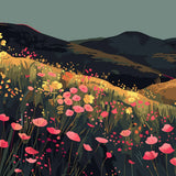 Colorful wildflower field on rolling hills with dark mountains