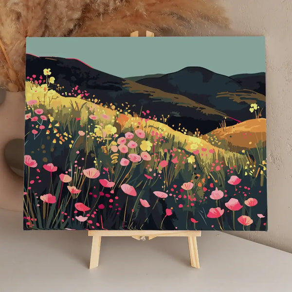 Colorful wildflower field on rolling hills with dark mountains