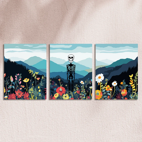 Skeleton standing in a colorful wildflower field with mountain backdrop