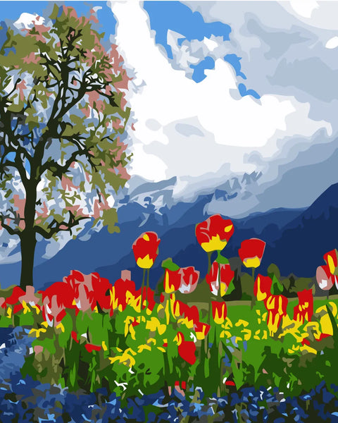 Vibrant tulip field with a tree and mountain backdrop