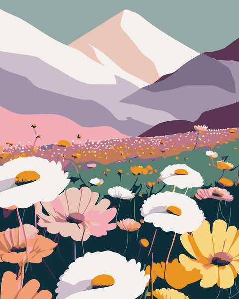 Colorful wildflowers blooming in a valley beneath snow-capped mountains