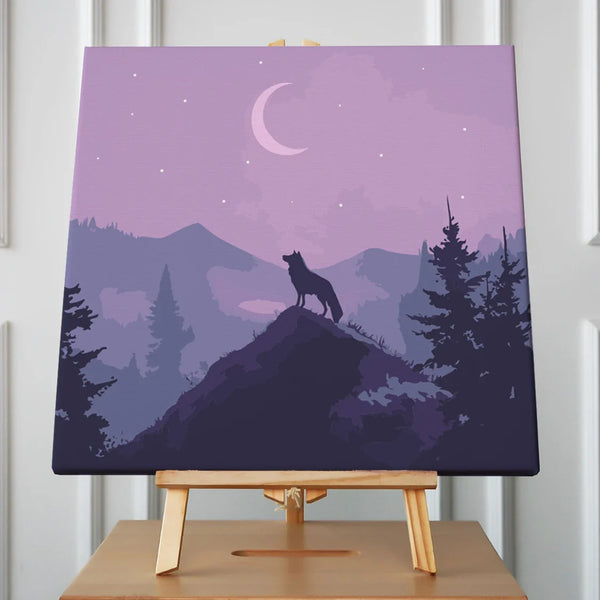 A lone wolf stands atop a mountain peak, silhouetted against a crescent moon and starry night sky, surrounded by misty purple mountains and pine trees.