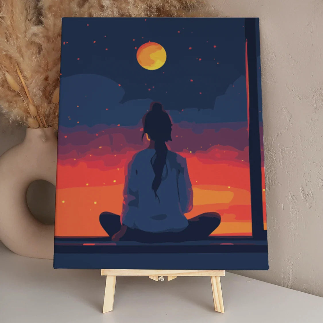 Woman sitting by window watching sunset and moonrise sky