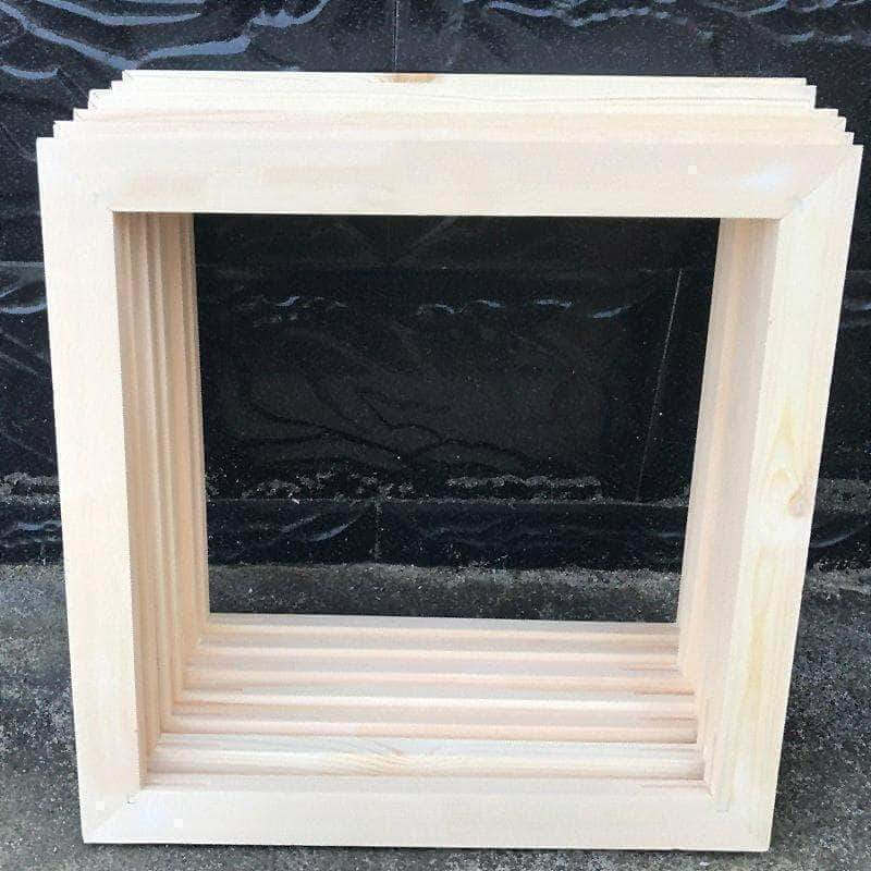 Stack of oak wood frames for 16x20 inch paint-by-numbers canvases – natural finish