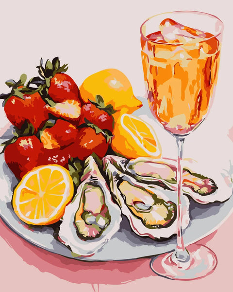 A plate of oysters, strawberries, lemons, and a cocktail glass