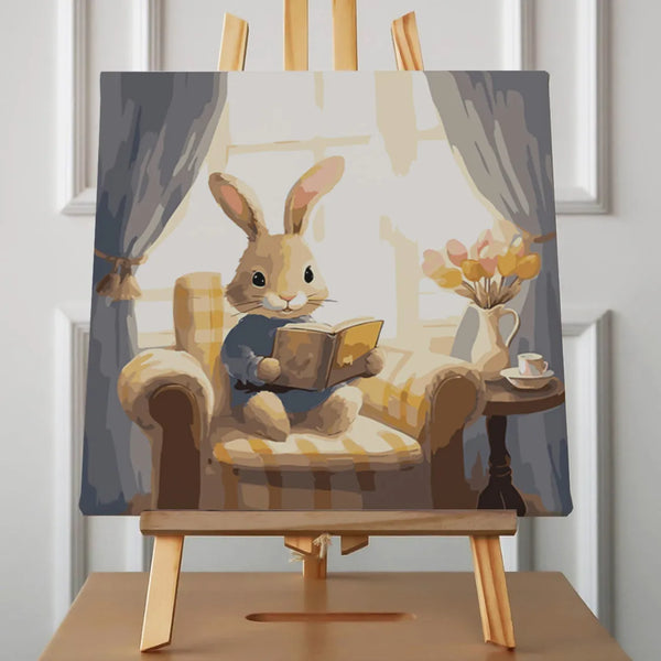 Painting of a cozy rabbit reading a book in an armchair