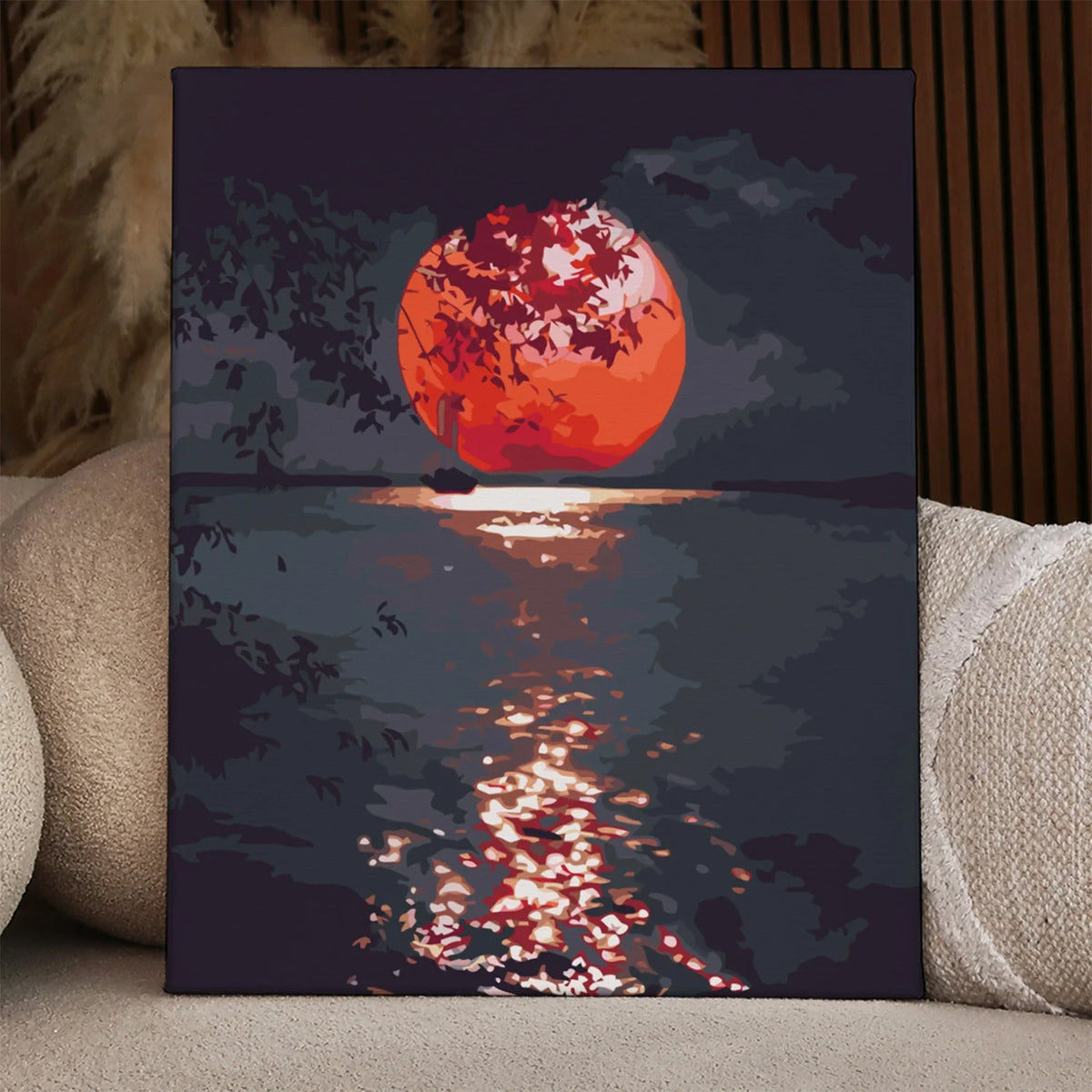 Sailboat on water with glowing red sunset and tree silhouette painting