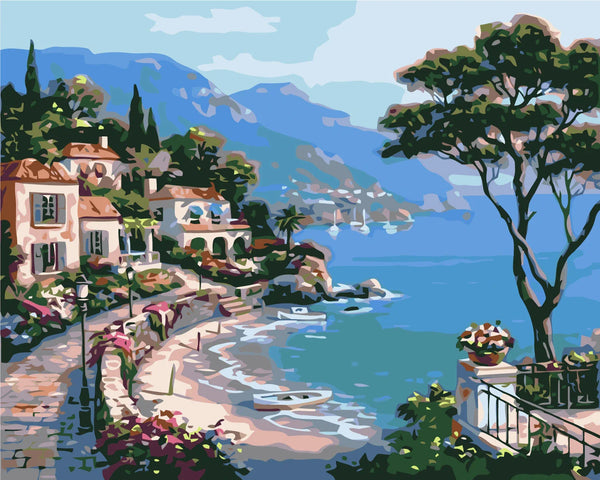 Coastal village painting with seaside villas, blue water, and boats