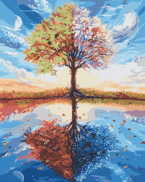 Tree representing four seasons reflected in a tranquil lake