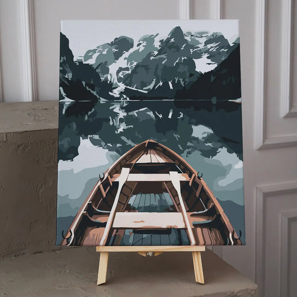 Wooden boat on a calm lake surrounded by mountains