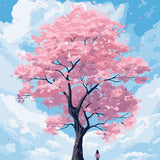 Woman standing under a blooming pink cherry blossom tree